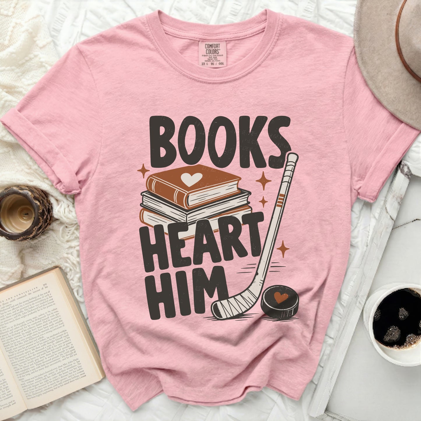 Pink t-shirt with "Books Heart Him" text and hockey imagery.