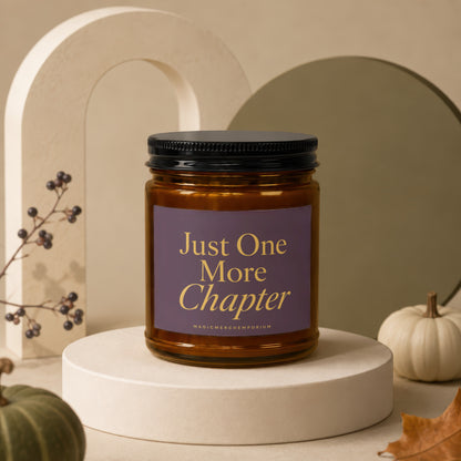Amber jar candle with purple label saying "Just One More Chapter".