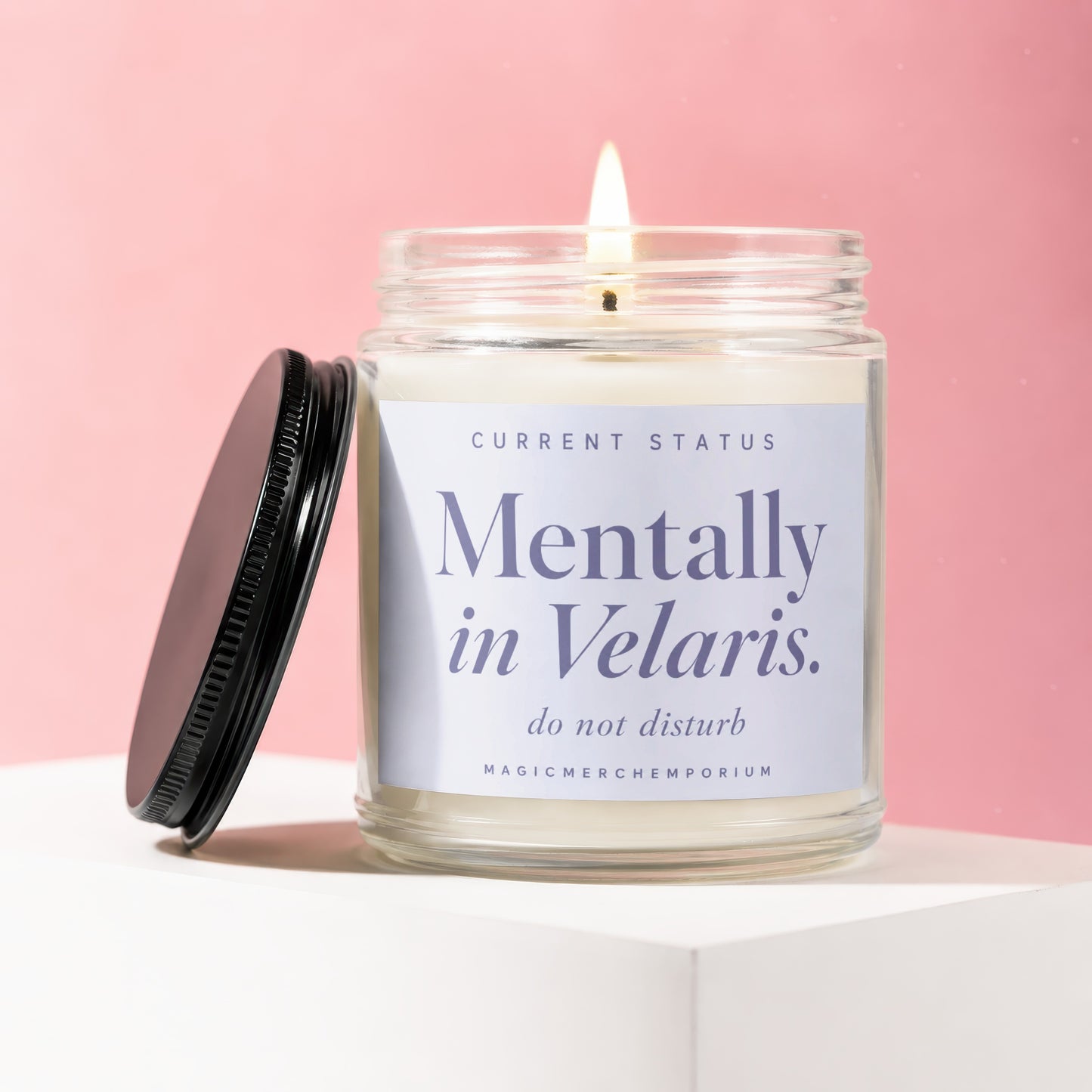 Glass jar candle with lit wick and "Mentally in Velaris. do not disturb" label.