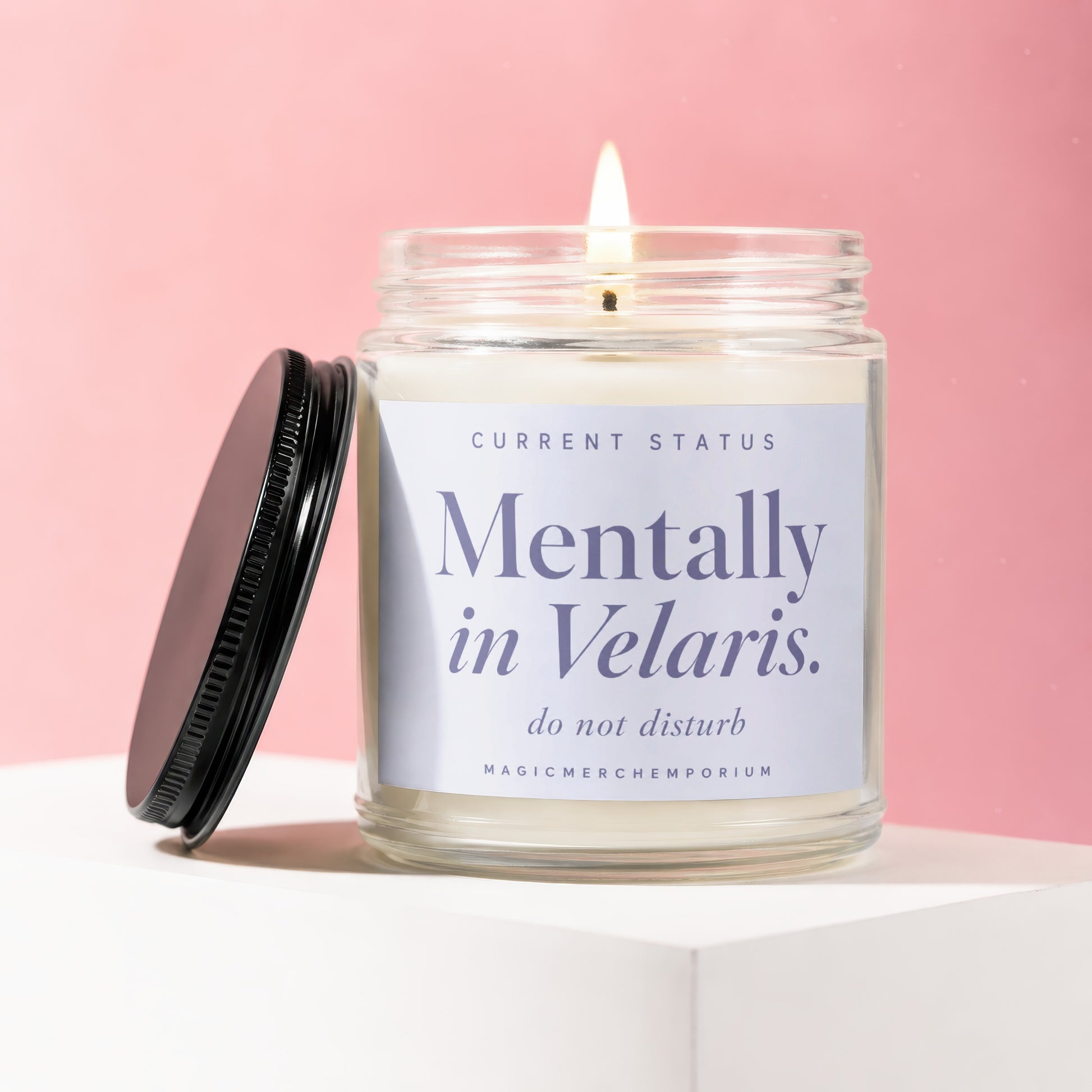 Glass jar candle with lit wick and "Mentally in Velaris. do not disturb" label.