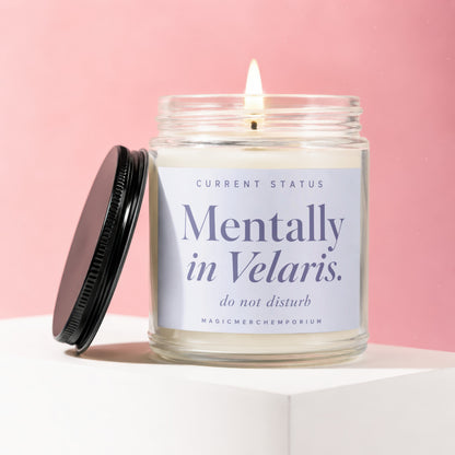 Glass jar candle with lit wick and "Mentally in Velaris. do not disturb" label.