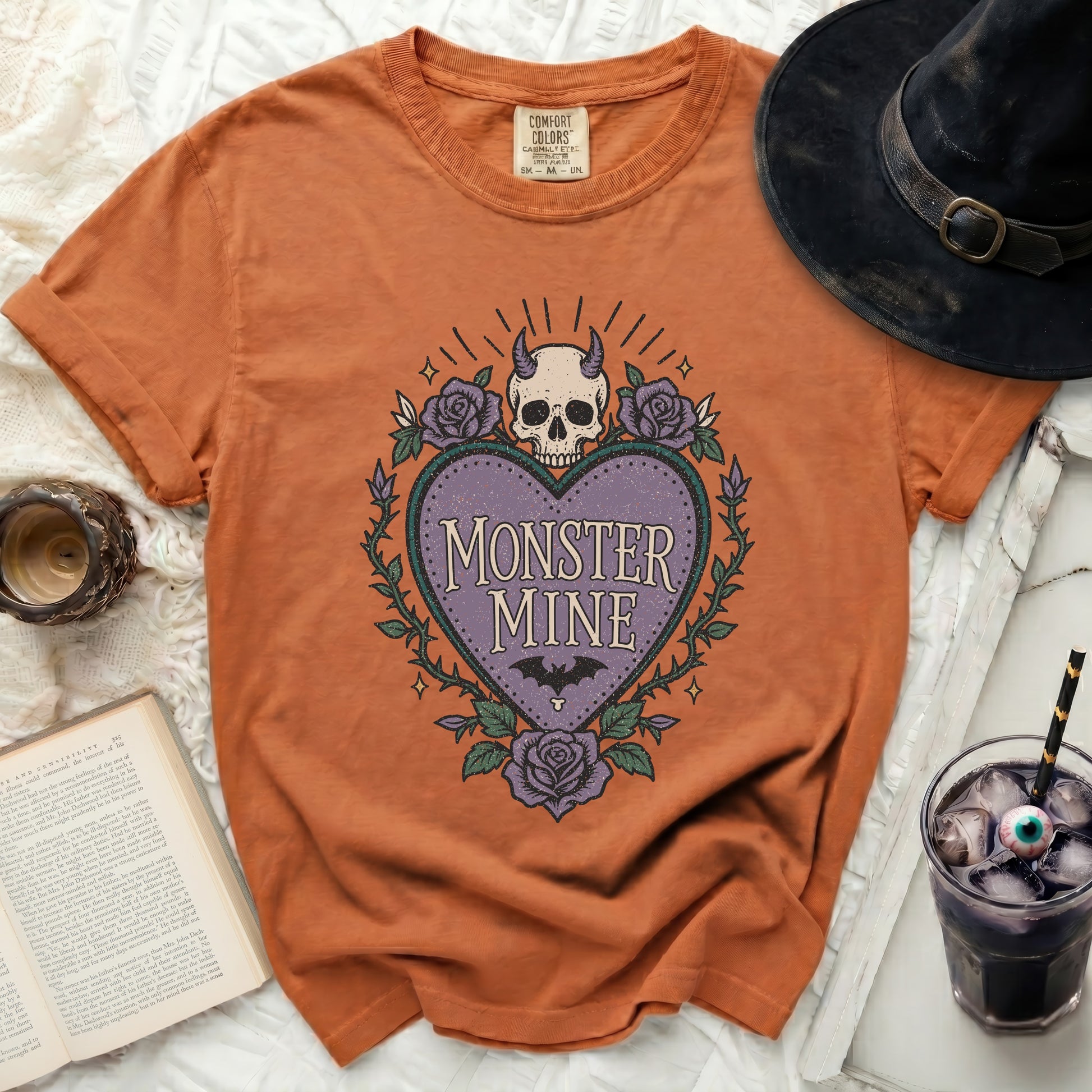 Orange t-shirt with "Monster Mine" heart graphic and roses.
