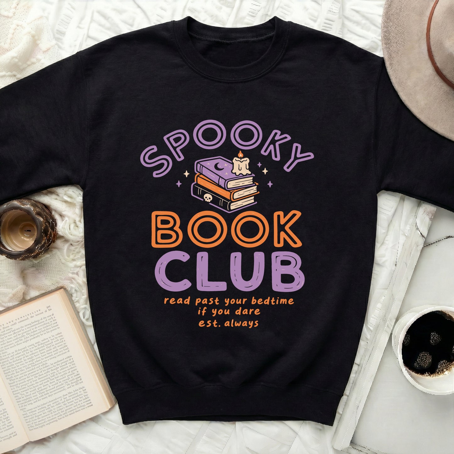 Black sweatshirt with "Spooky Book Club" text, books, candle, and skull graphic.