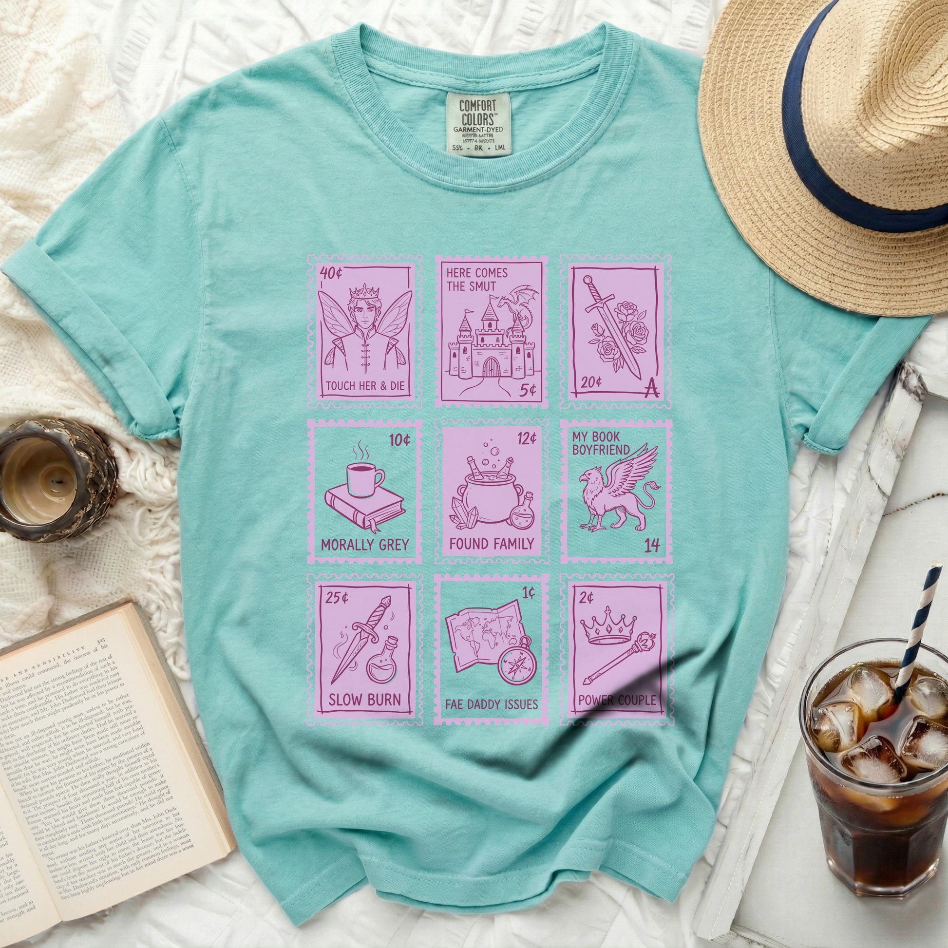 T-shirt with square icons representing book tropes: castle, fairy, book, and crown.