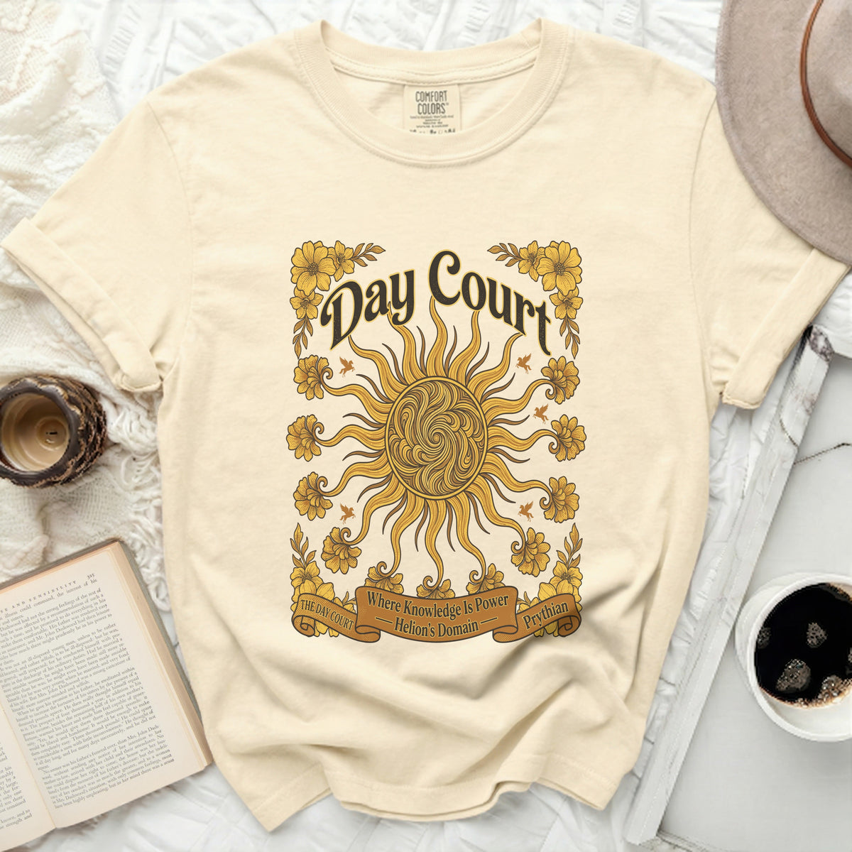 Cream t-shirt with "Day Court Where Knowledge Is Power Helion's Domain Prythian" and sun graphic.