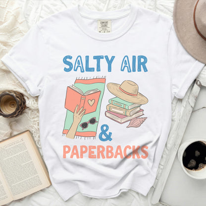 White t-shirt with "Salty Air & Paperbacks" and books graphic.
