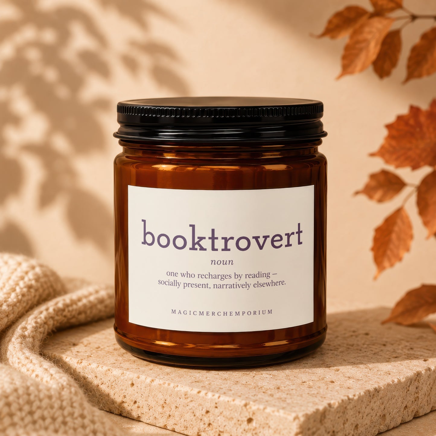 Amber jar candle with "booktrovert" label, described as "one who recharges by reading."