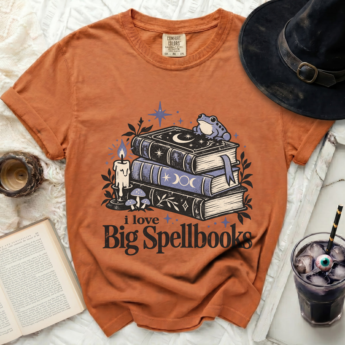 Orange t-shirt with spellbook graphic and text "i love Big Spellbooks".