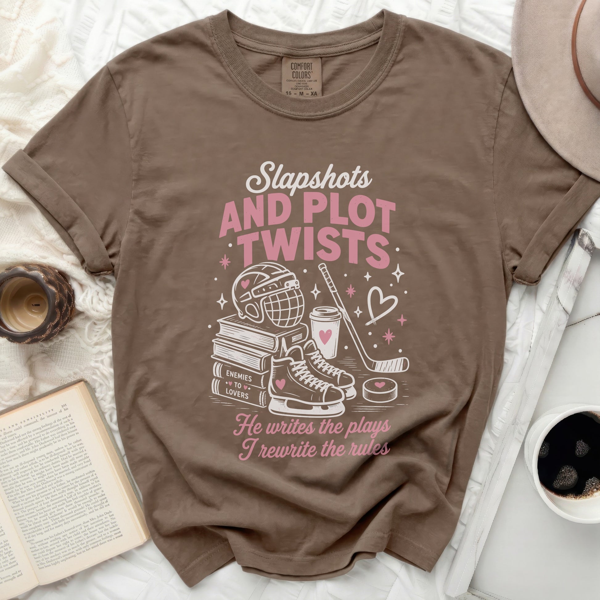 T-shirt with "Slapshots and Plot Twists" text and hockey graphics.