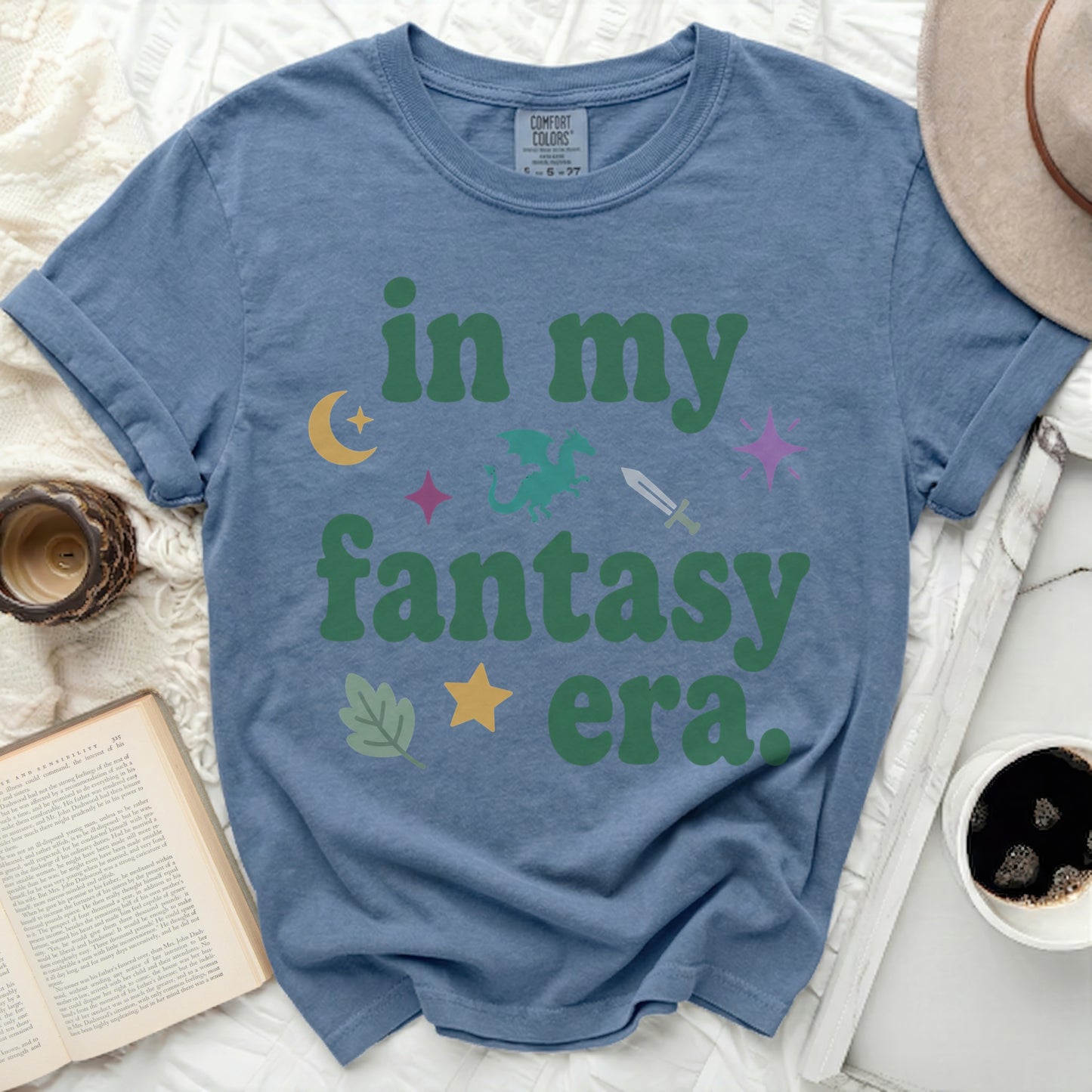 Blue t-shirt with "in my fantasy era." text and fantasy icons.