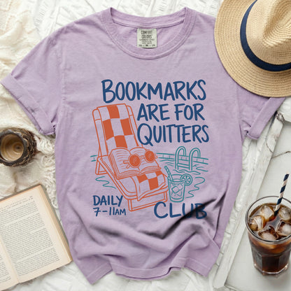 Purple t-shirt with "Bookmarks Are For Quitters" graphic and pool scene.