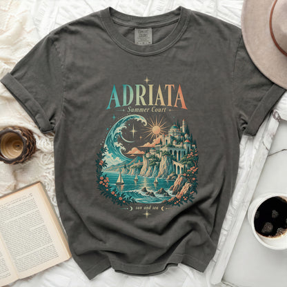 T-shirt with "ADRIATA Summer Court sun and sea" graphic featuring a coastal town and ocean scene.
