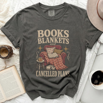 Gray t-shirt with "BOOKS BLANKETS and CANCELLED PLANS" text and illustration.