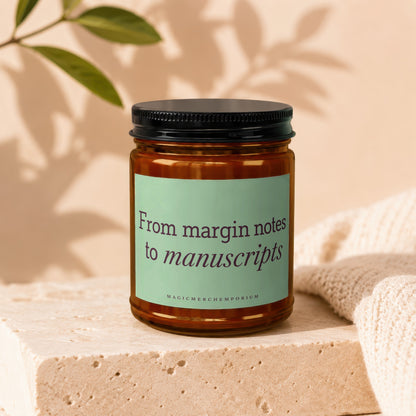 Amber jar candle with light green label reading "From margin notes to manuscripts"