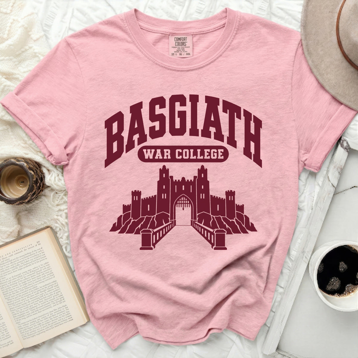 Pink Comfort Colors shirt with maroon "BASGIATH WAR COLLEGE" and castle graphic.