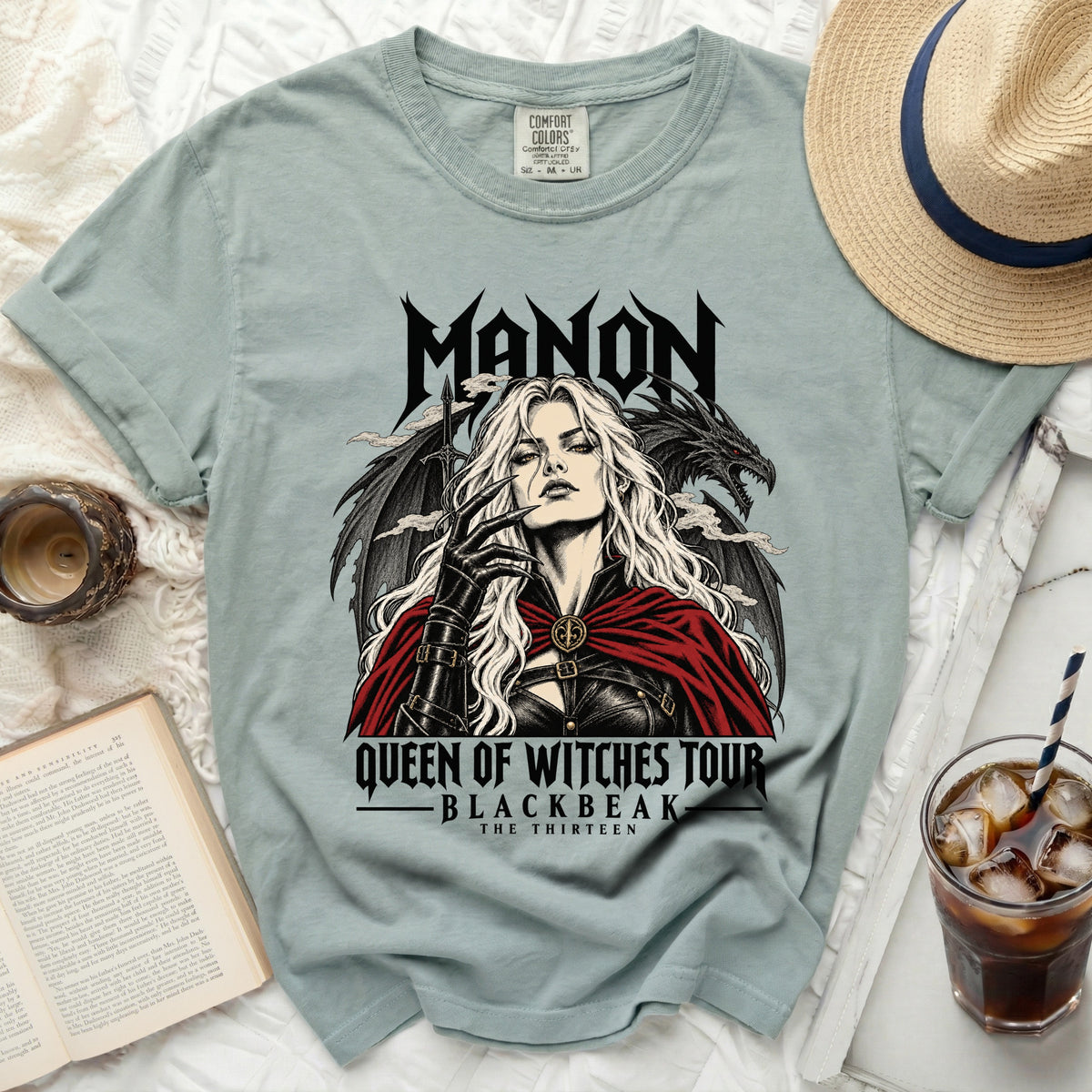 T-shirt graphic with "MANON QUEEN OF WITCHES TOUR BLACKBEAK THE THIRTEEN" text.