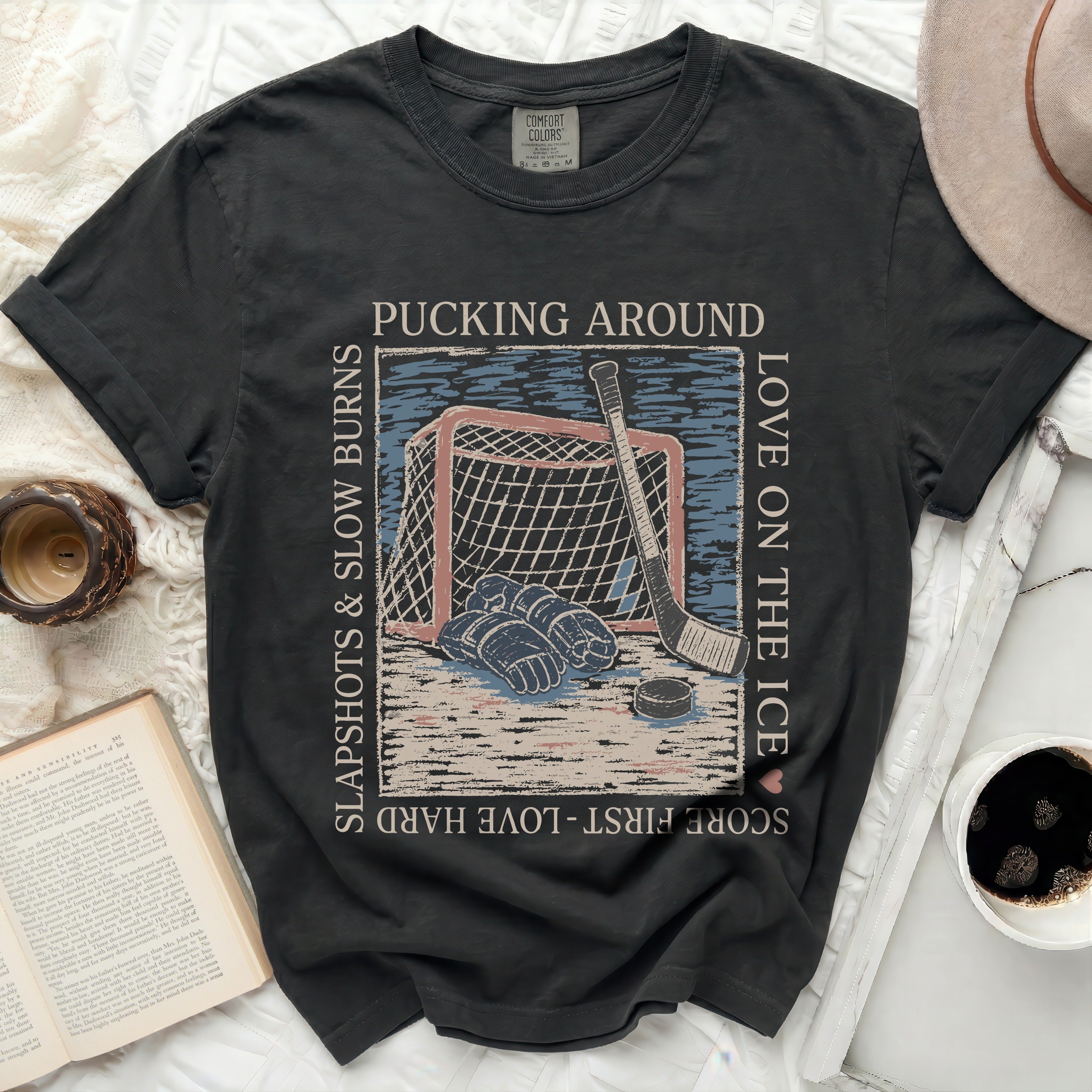 Black Comfort Colors t-shirt with hockey graphic and text.