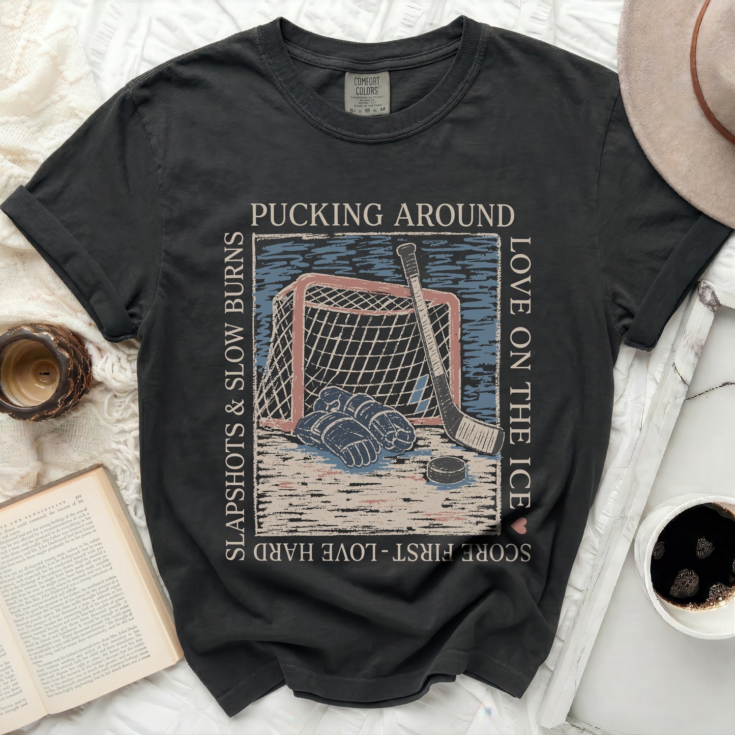 Black Comfort Colors t-shirt with hockey graphic and text.