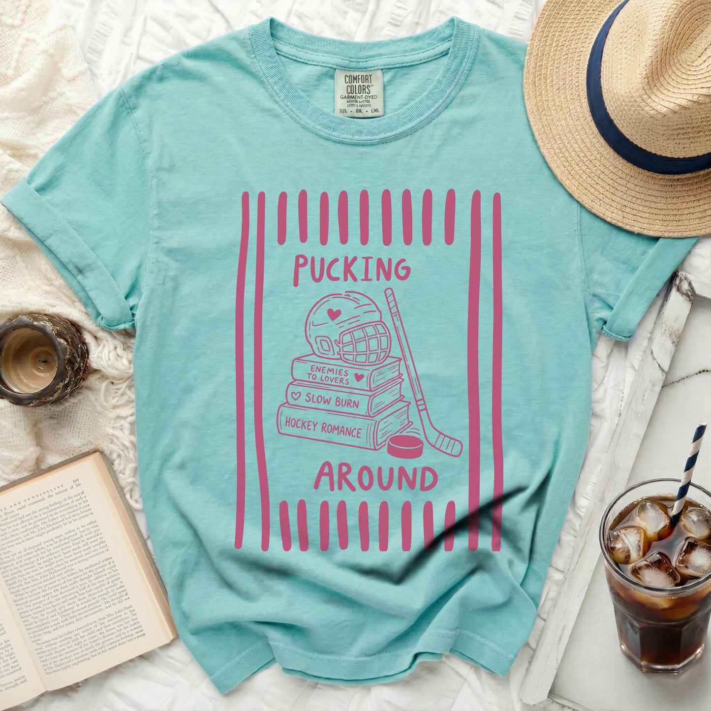 Aqua t-shirt with pink hockey romance graphic and text.