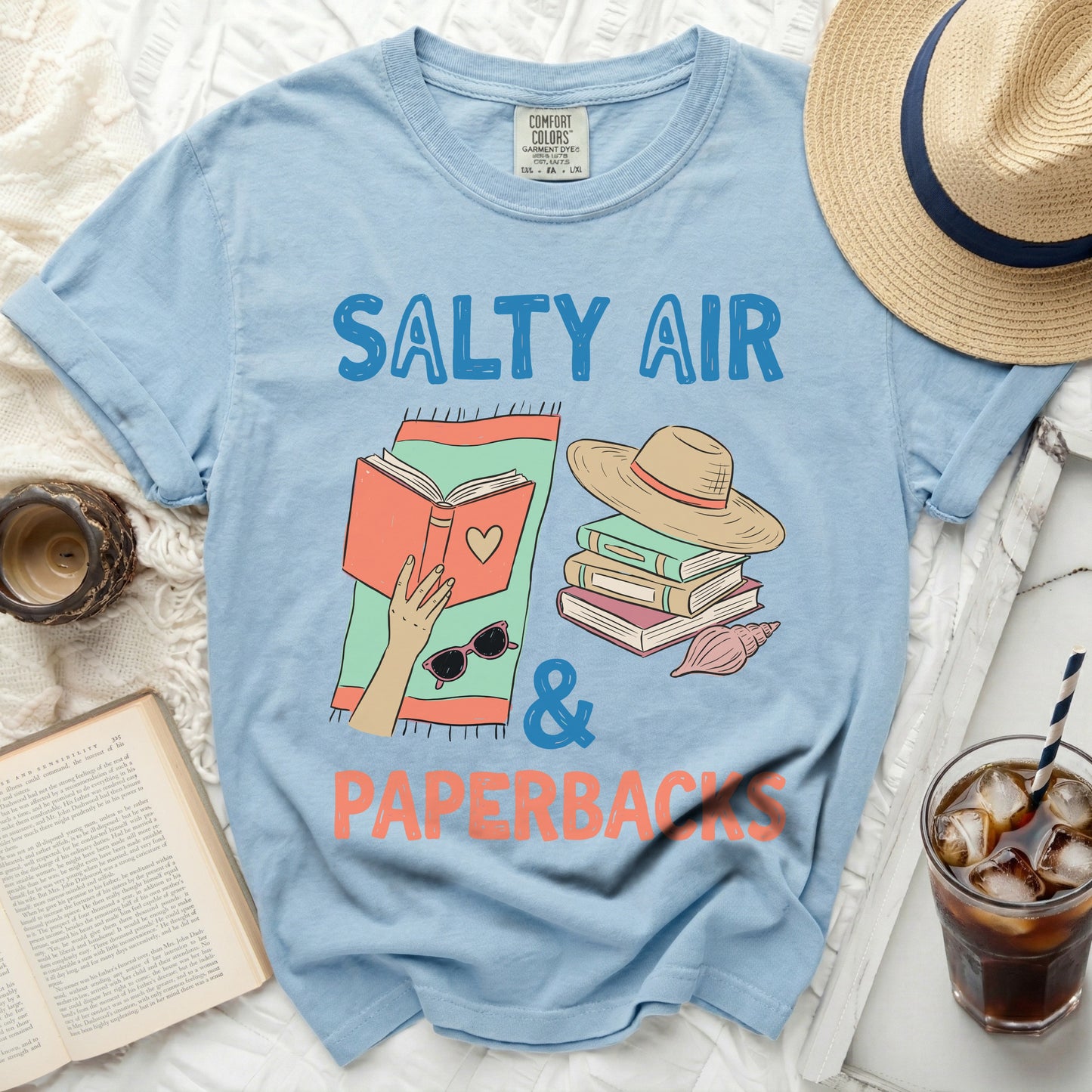 Light blue t-shirt with "Salty Air & Paperbacks" text, books, and sunglasses.