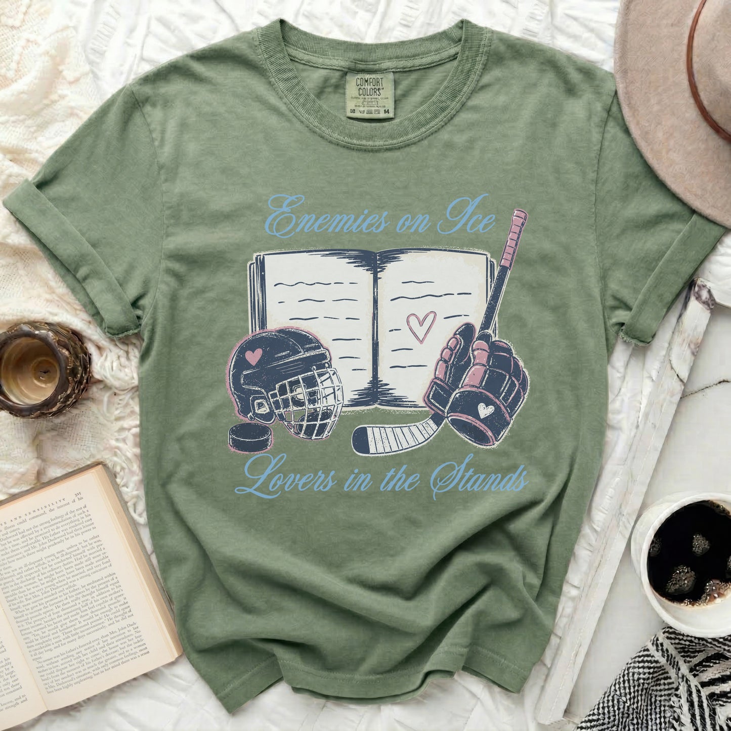 Green t-shirt with "Enemies on Ice Lovers in the Stands" text and hockey imagery.