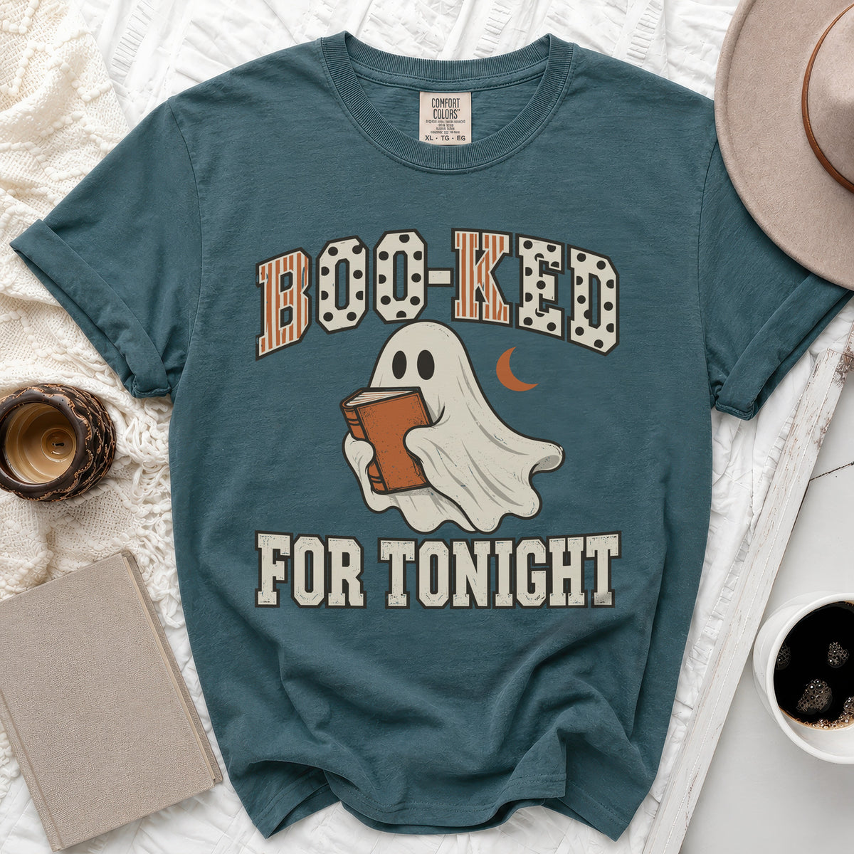 Teal t-shirt with "BOO-KED FOR TONIGHT" text and a ghost holding a book.