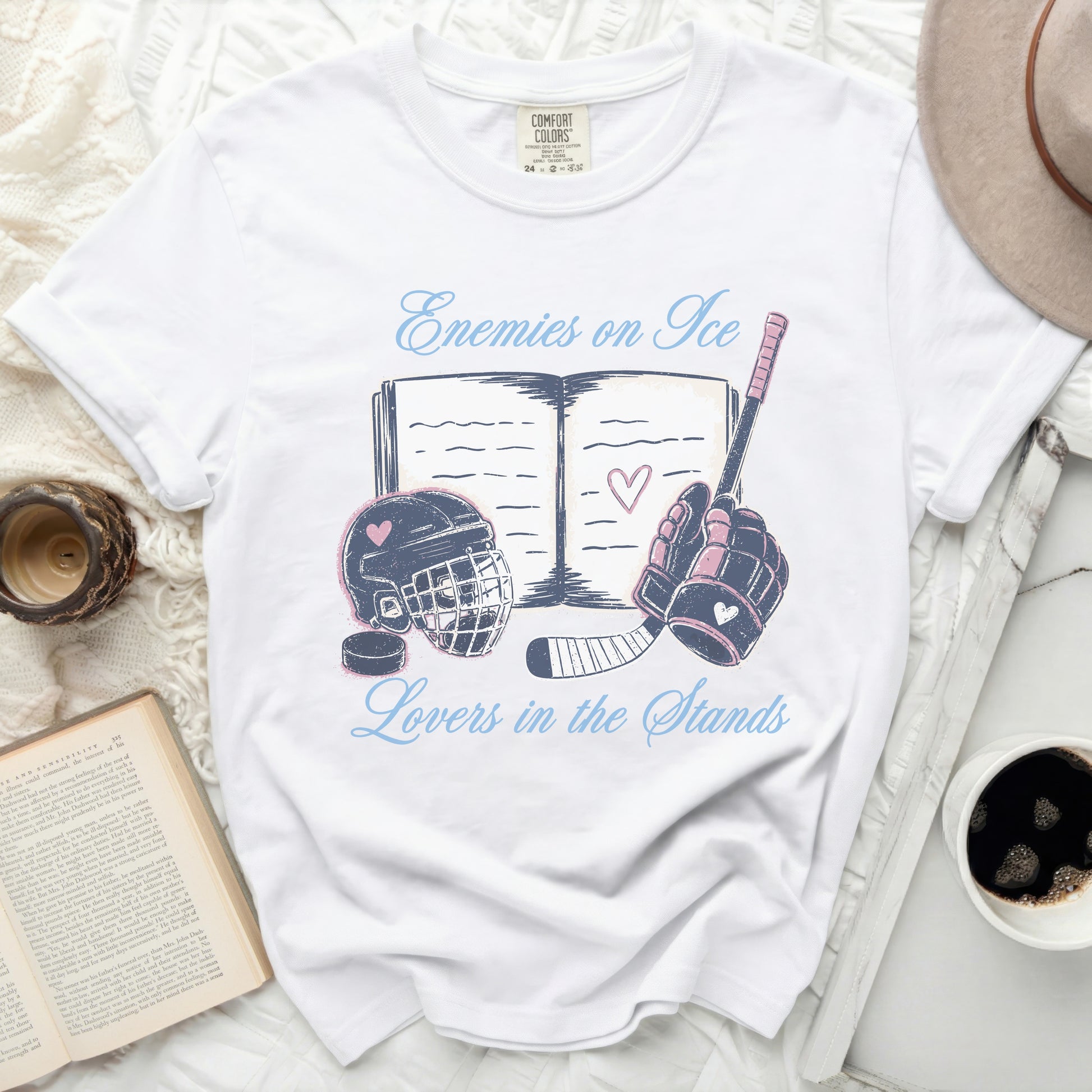 White t-shirt with "Enemies on Ice, Lovers in the Stands" and hockey graphics.