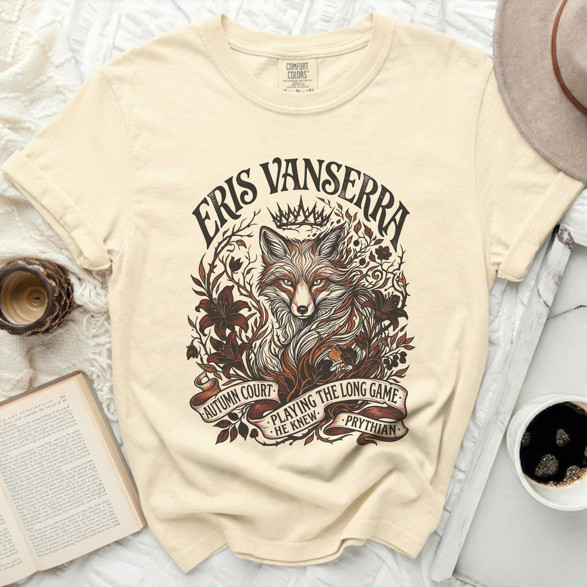 Cream t-shirt with a fox illustration and text: "Eris Vanserra, Autumn Court, Playing the Long Game, He Knew, Phrythian"