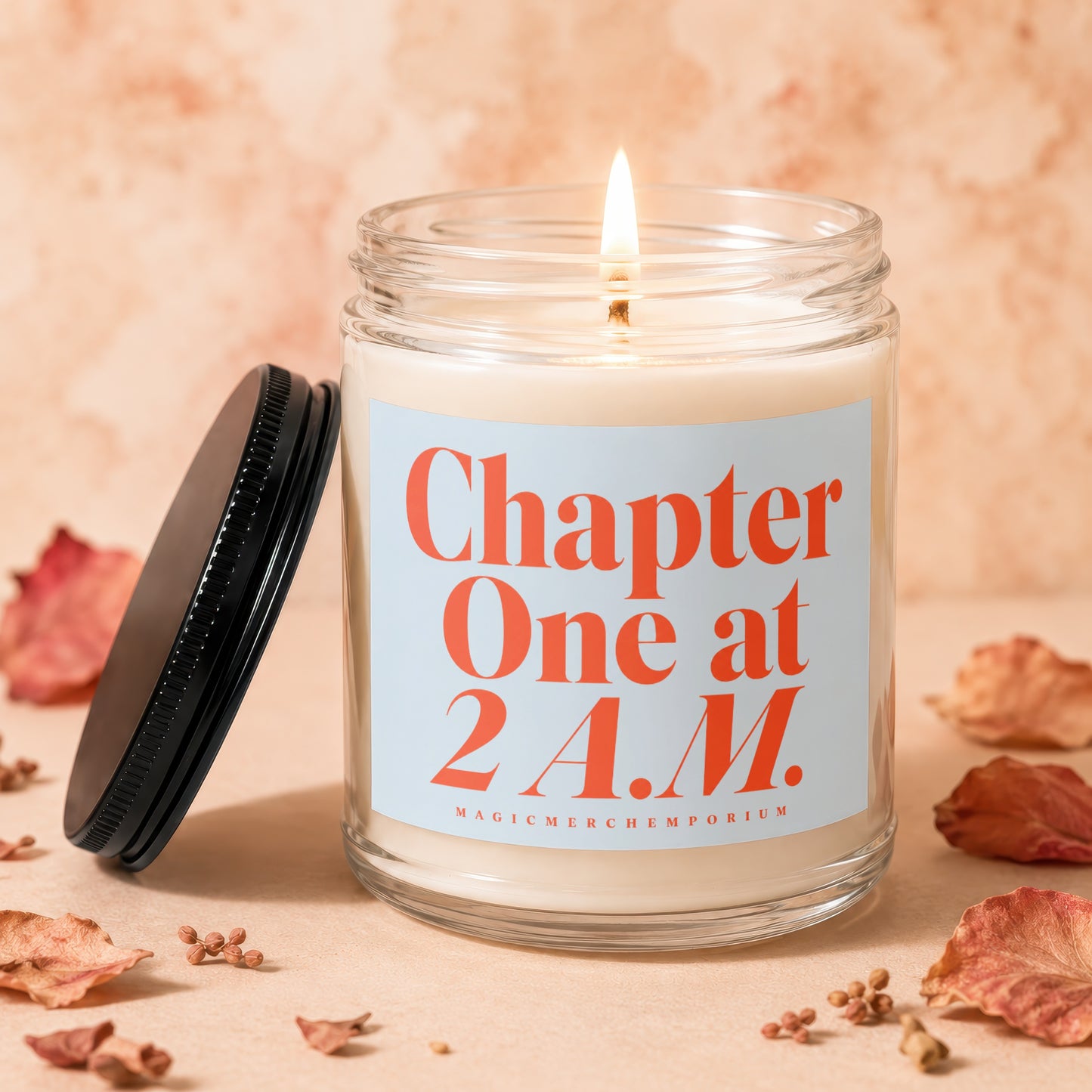 Glass candle with lit wick and label reading "Chapter One at 2 A.M."