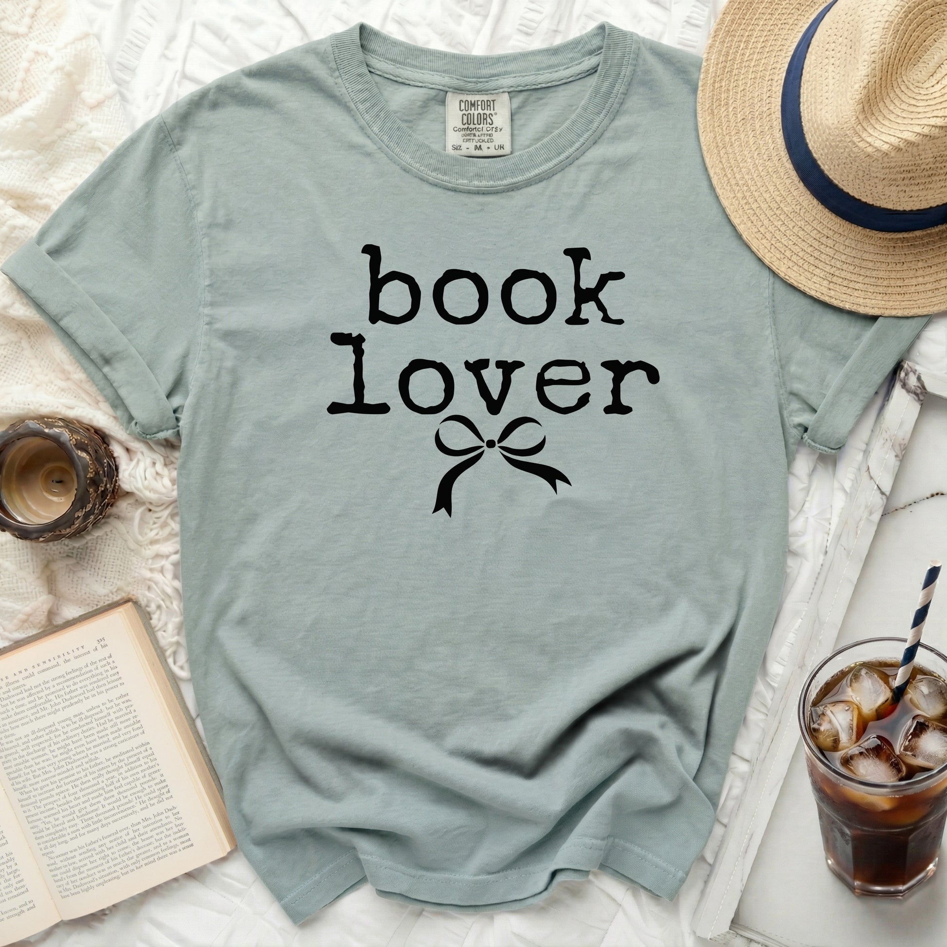Comfort Colors t-shirt with "book lover" and bow graphic.