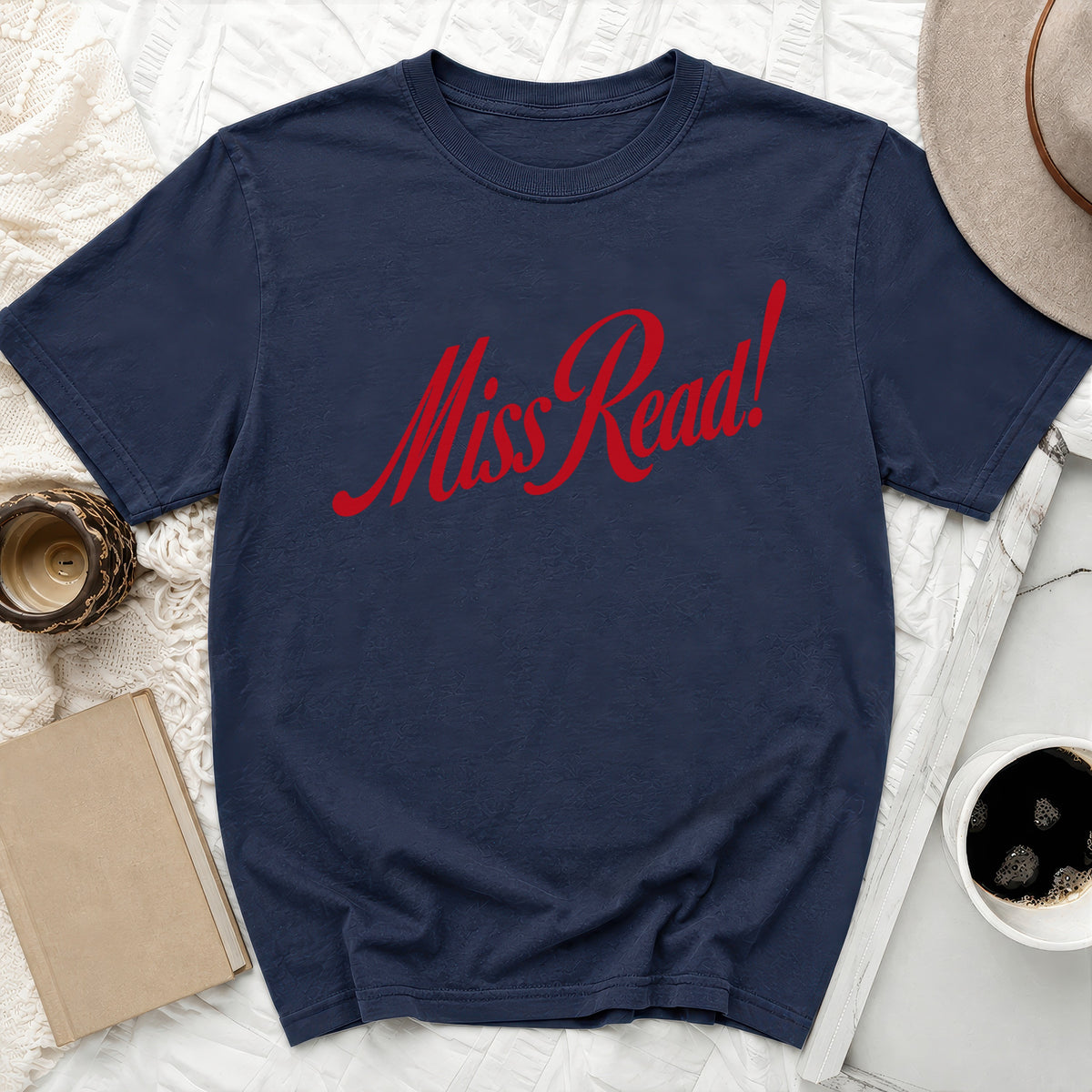 Navy t-shirt with red "Miss Read!" text, styled with a hat and book.