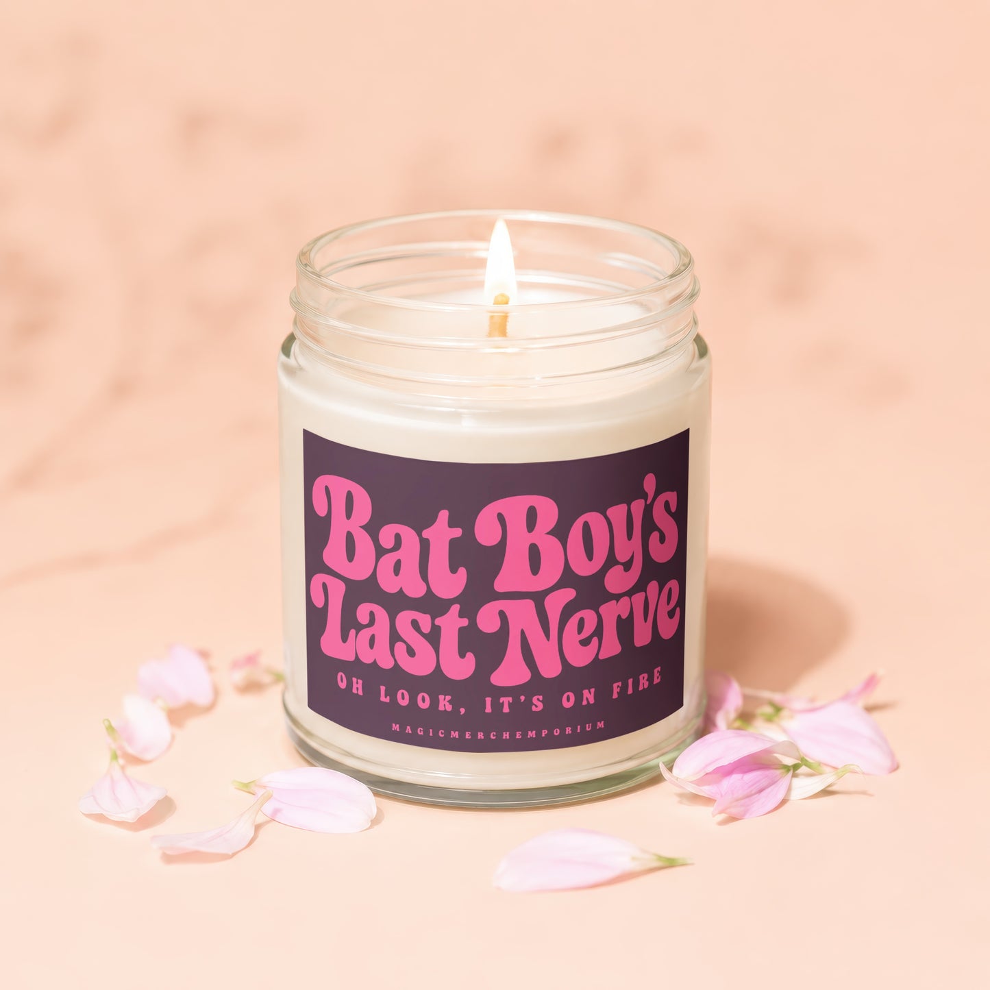 Candle with "Bat Boy's Last Nerve" text and a lit wick, surrounded by petals.