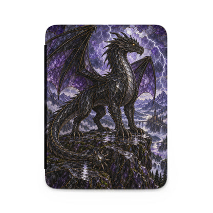 Black dragon perched on a cliff overlooking a castle and waterfall.