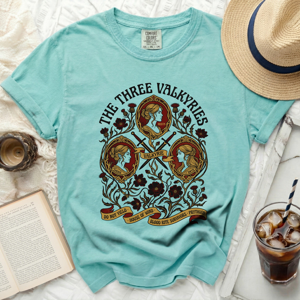"The Three Valkyries" t-shirt features three women, swords, and floral motifs.