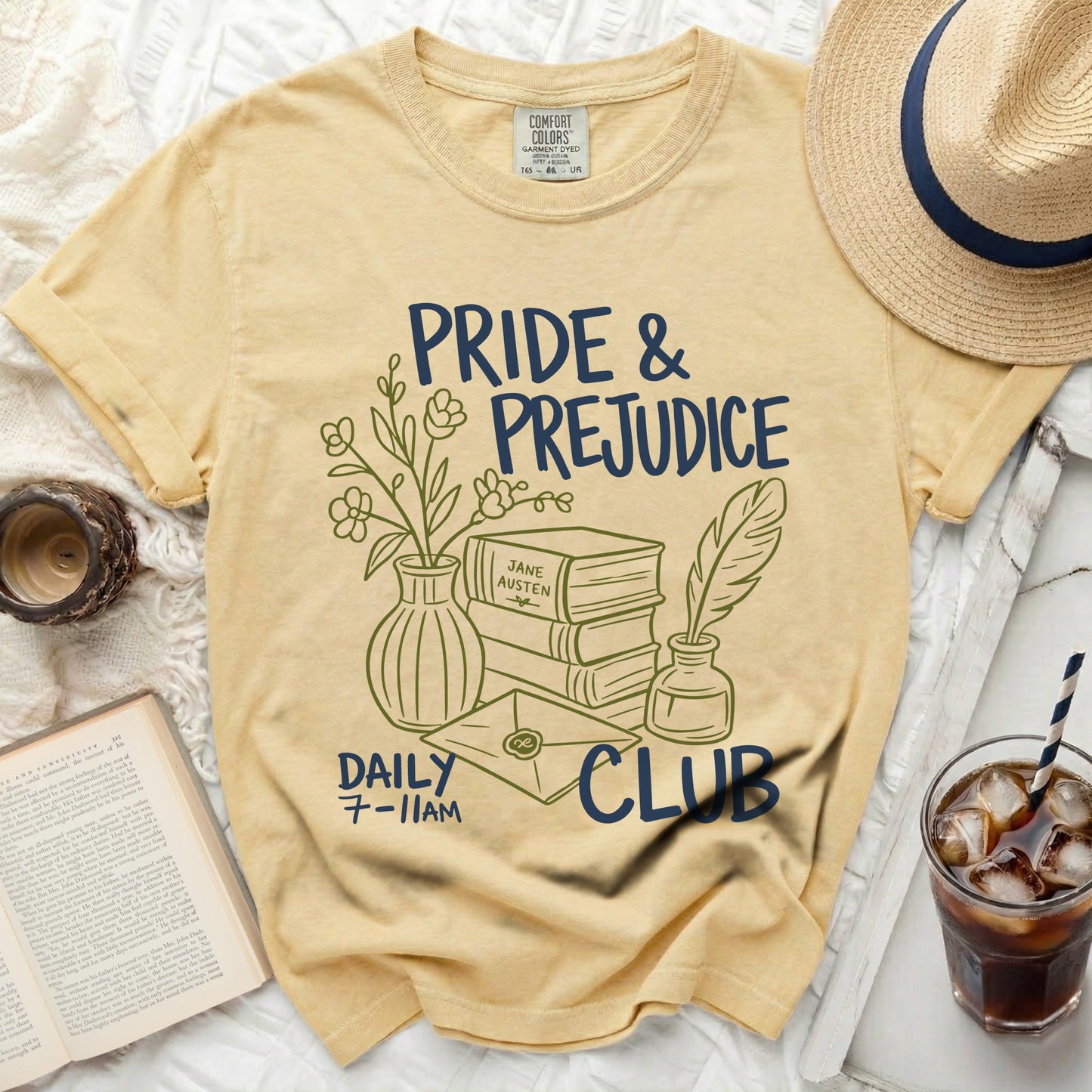 Yellow t-shirt with Pride & Prejudice Daily Club graphic and stacked books.