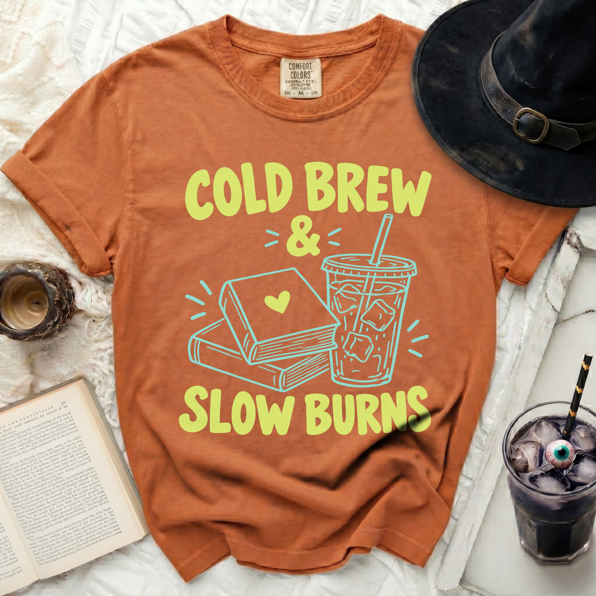 Orange t-shirt with "Cold Brew & Slow Burns" text and illustrations.