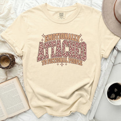 Cream t-shirt with "Emotionally Attached to Fictional People" text and leopard print.