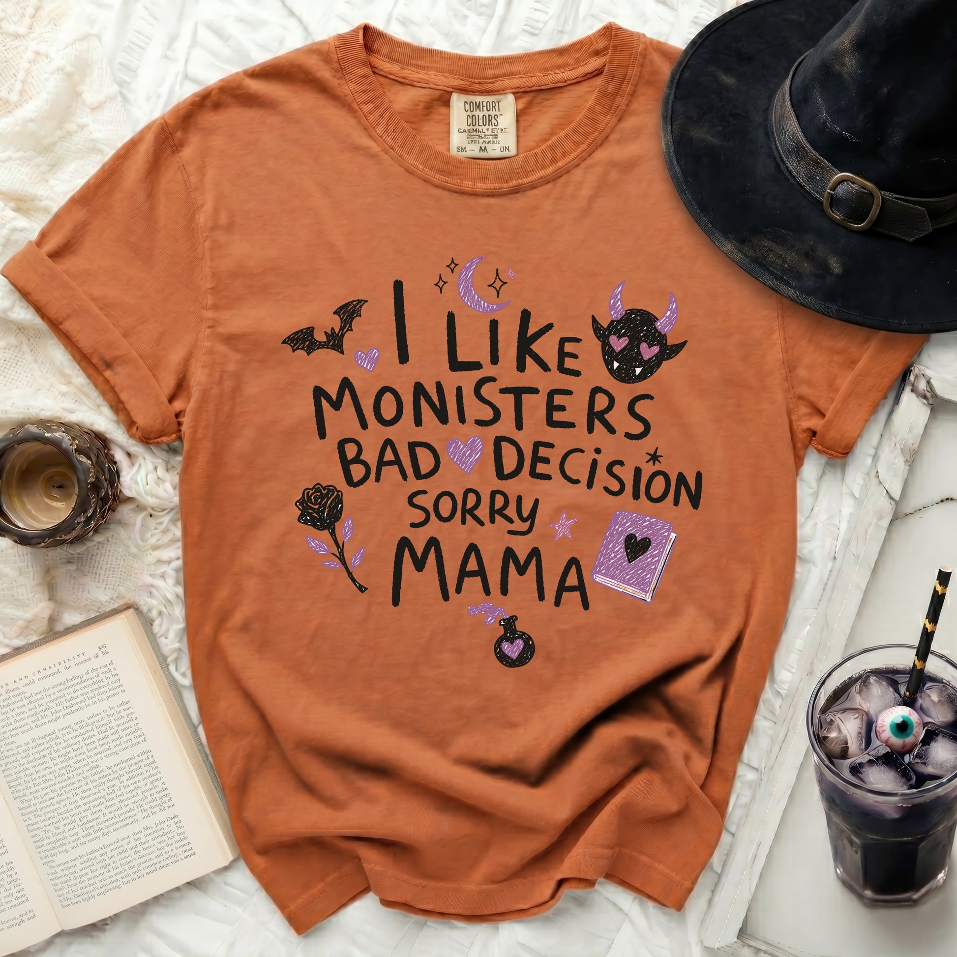 Orange Comfort Colors t-shirt with "I like monsters bad decisions sorry mama" text and Halloween graphics.