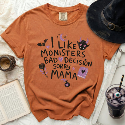 Orange Comfort Colors t-shirt with "I like monsters bad decisions sorry mama" text and Halloween graphics.