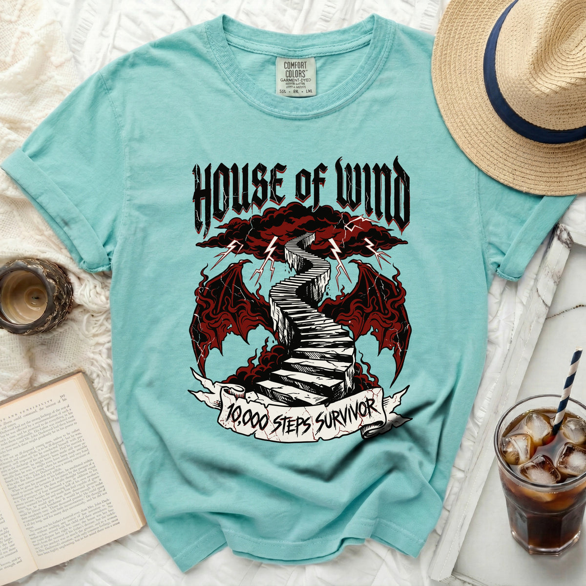 Teal t-shirt with "House of Wind" and "10,000 Steps Survivor" graphic.