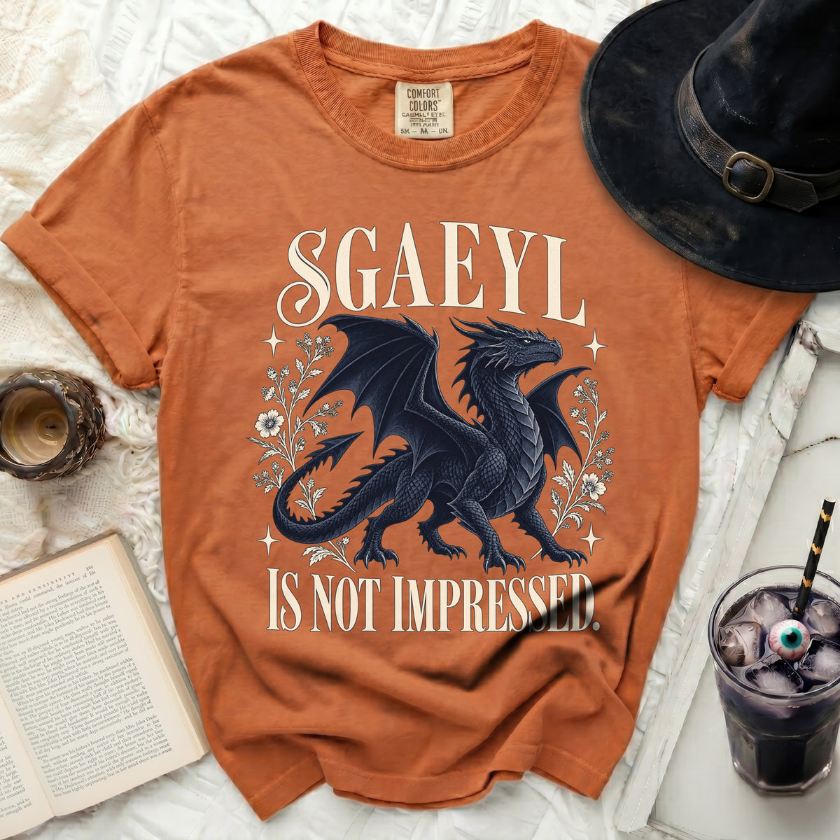 Orange t-shirt with a black dragon and text "SGAEYL IS NOT IMPRESSED".
