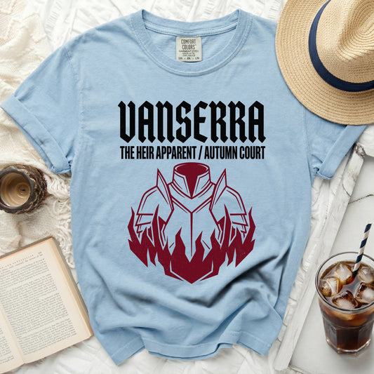 Light blue t-shirt with black Vanserra logo and red armor with flames design.