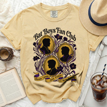 Yellow Bat Boys Fan Club t-shirt with black silhouettes and purple floral accents.