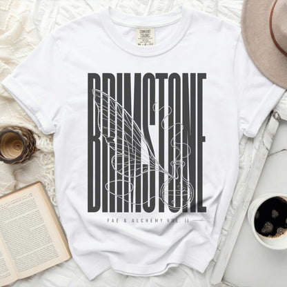 White t-shirt with "Faerie & Alchemy Vol. II" text and winged potion bottle.