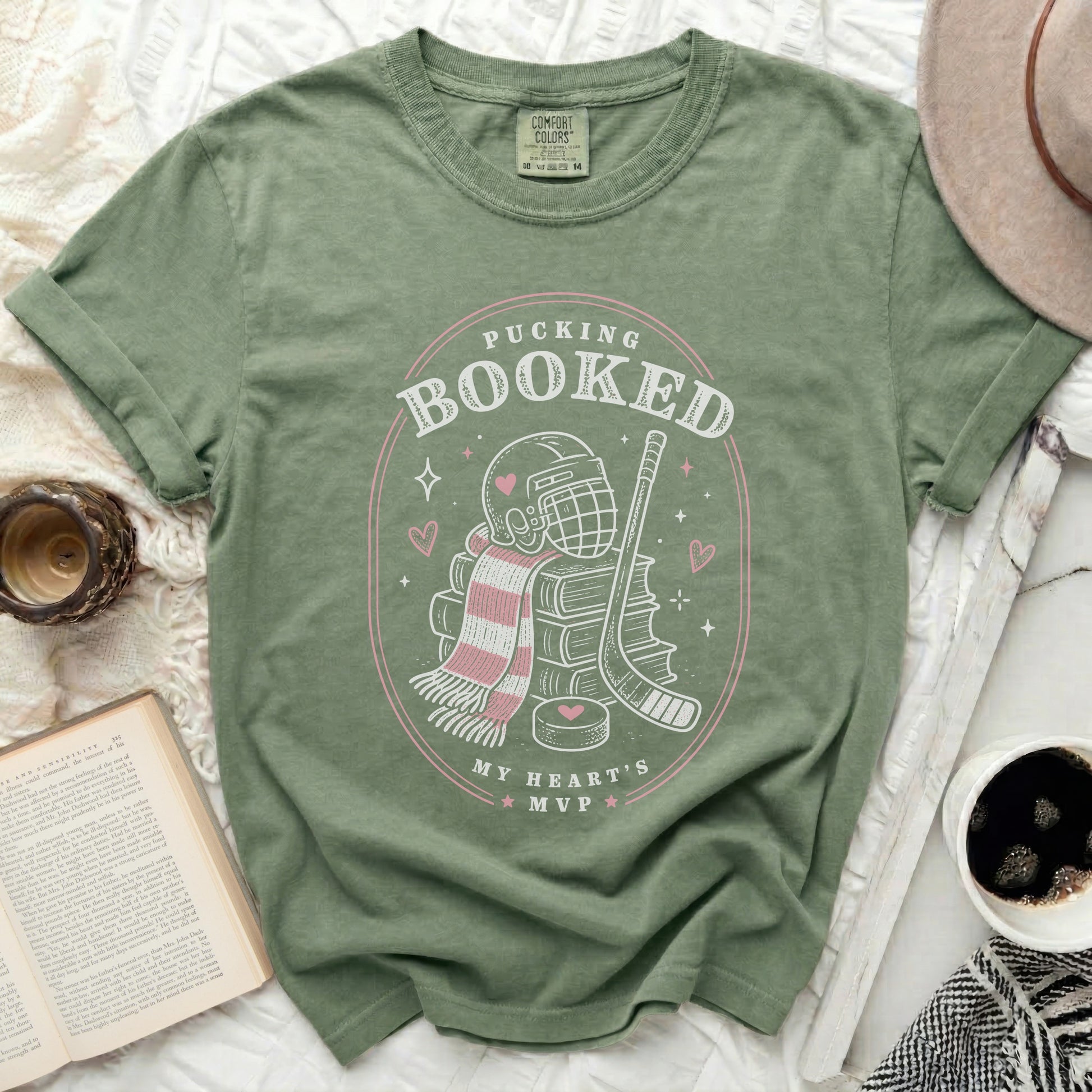 Green t-shirt with "Pucking Booked My Heart's MVP" text and hockey graphics.