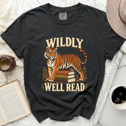 Black t-shirt with a tiger standing on books, text "WILDLY WELL READ".