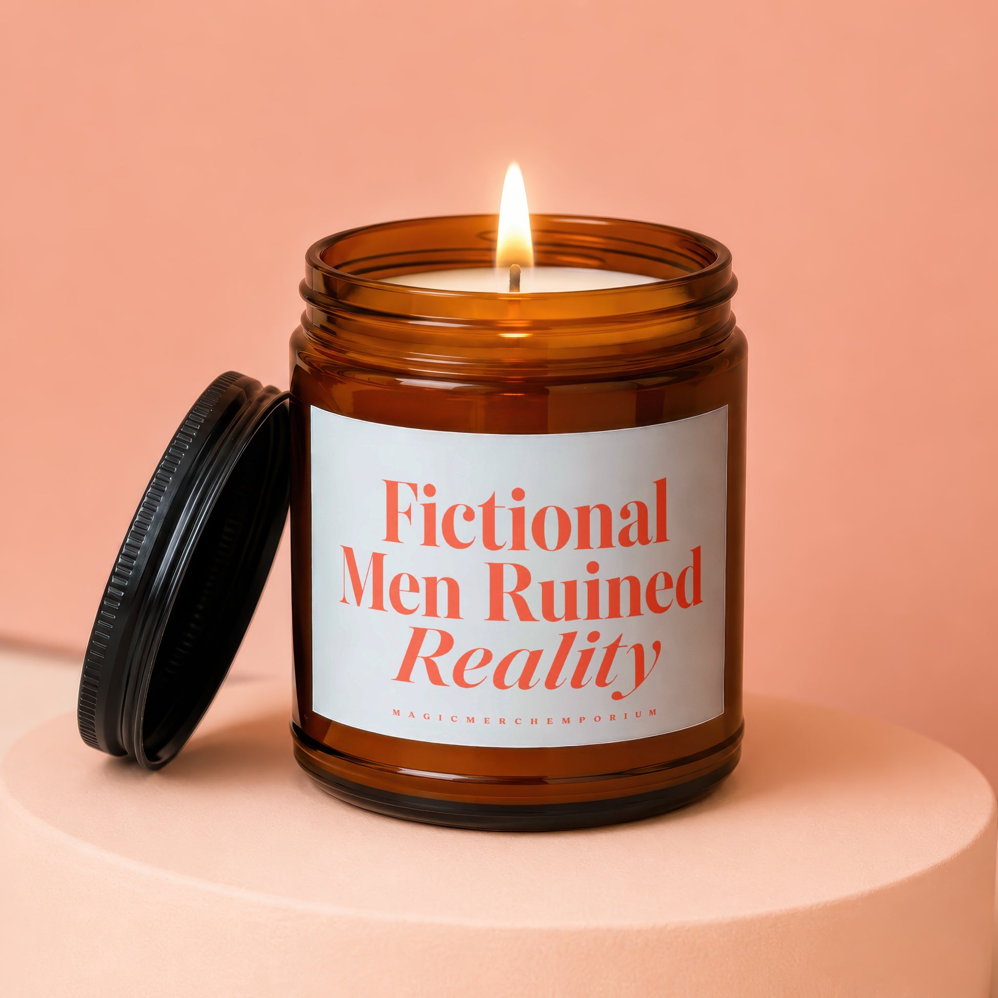 Amber jar candle with lit wick and black lid, reads "Fictional Men Ruined Reality".