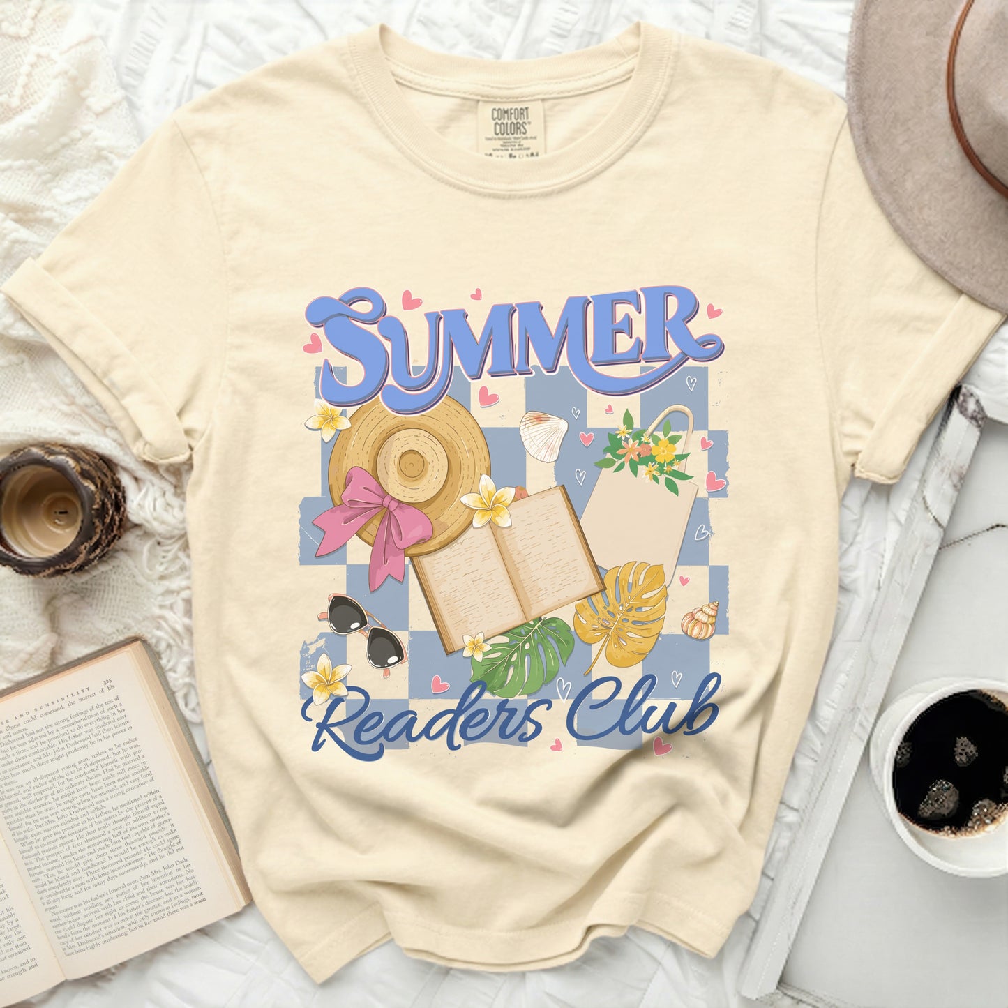Cream t-shirt with "Summer Readers Club" graphic featuring a straw hat and open book.