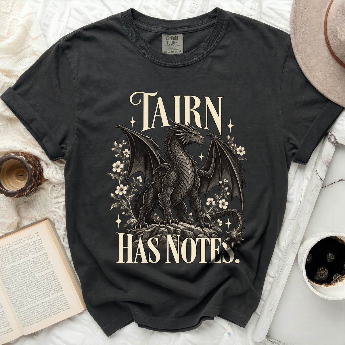 Dark t-shirt with a dragon and floral design, reading "TAIRN HAS NOTES."