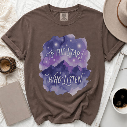 Brown t-shirt with watercolor mountains and stars graphic that reads "To The Stars Who Listen."